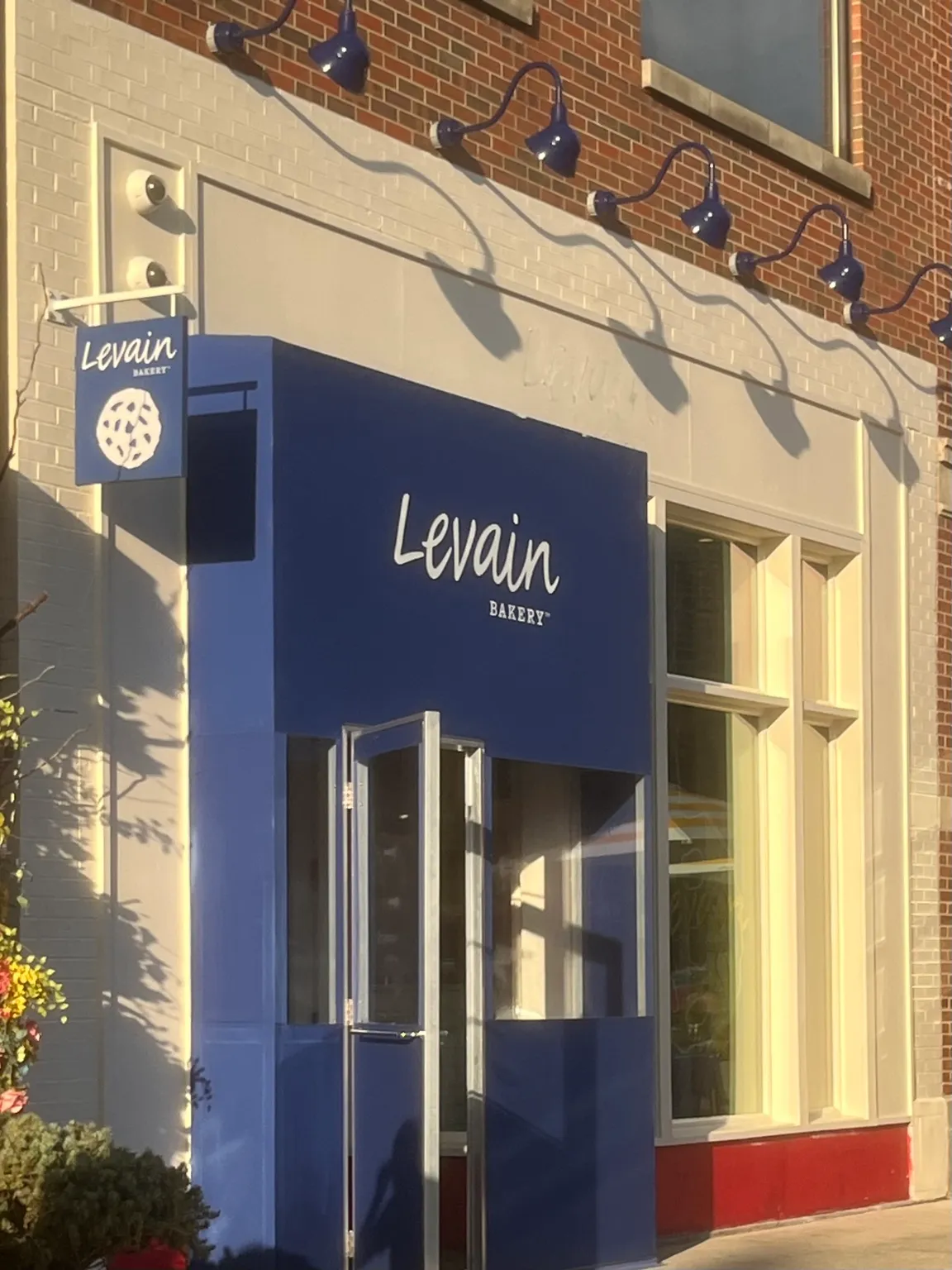 Finished commercial storefront exterior with blue and white architectural details
